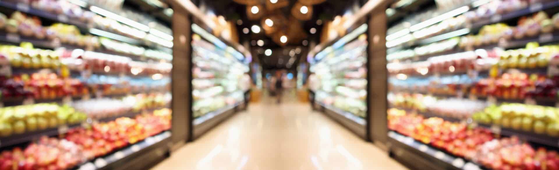 Grocery store shelves with fruits and vegetables blurred background