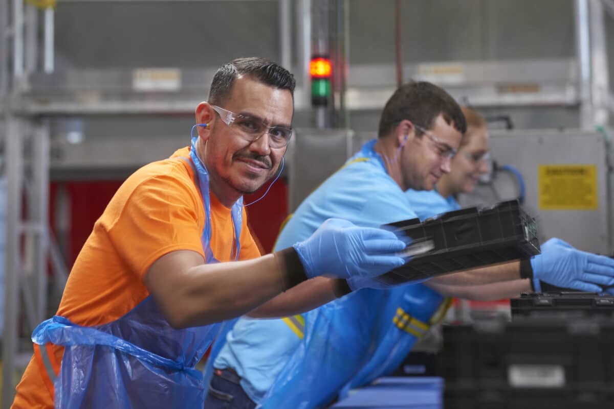 Tosca service center workers manage the pooling process of washing and sanitizing plastic crates for reuse, offering a sustainable alternative to single-use packaging.