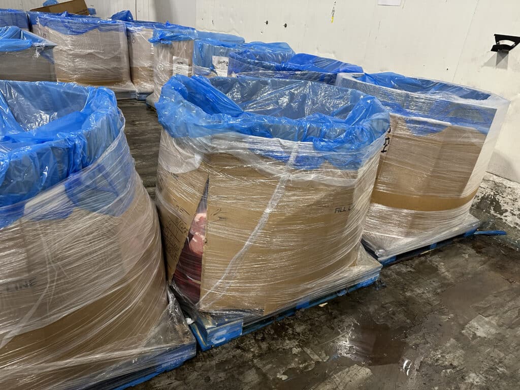 damaged bulk bin that has meat
